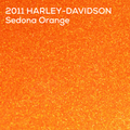 A close-up textured color swatch of metallic orange glitter with white text reading '2011 HARLEY-DAVIDSON Sedona Orange' in the upper left corner.