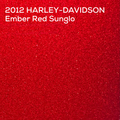 A close-up textured color swatch of a red glittery or sparkly material with white text at the top reading '2012 HARLEY-DAVIDSON Ember Red Sunglo'.