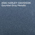 A close-up textured color swatch labeled '2021 HARLEY-DAVIDSON Gauntlet Gray Metallic' in white text at the top, showing a dark blue-gray metallic fabric or material surface.