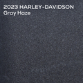 A textured color swatch labeled '2023 HARLEY-DAVIDSON Gray Haze' in white text at the top, showing a dark charcoal gray painted surface.